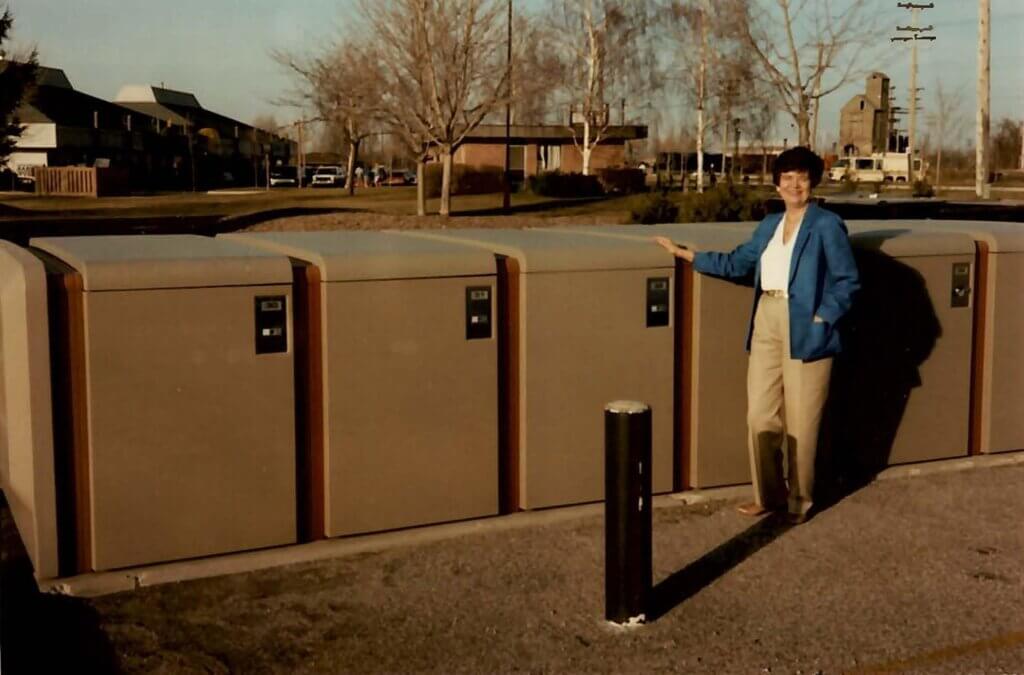 Marjorie stands next to a bank of ProPark lockers; 1972