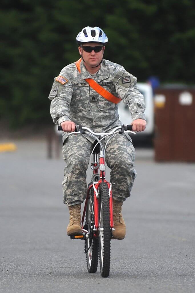 military service member on bike